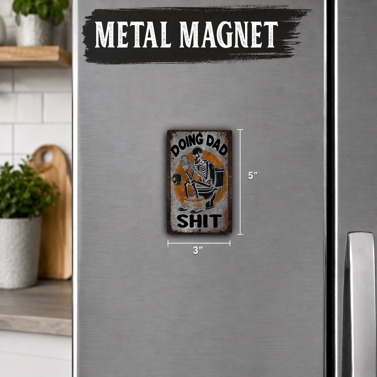 a small metal magnet with a humorous text and graphic on it, placed on a refrigerator.