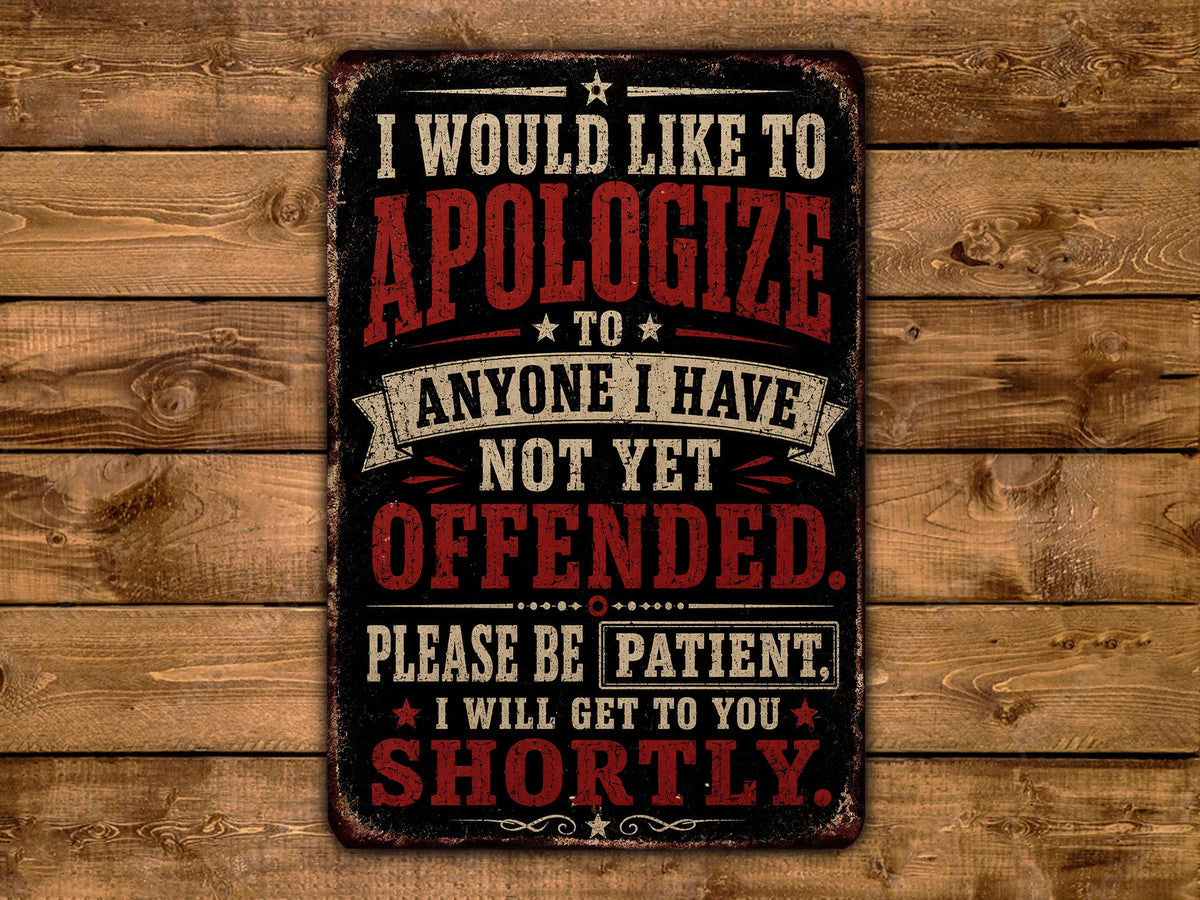 a sign with a bold, red and black text message that reads: "I WOULD LIKE TO APOLOGIZE TO ANYONE I HAVE NOT YET OFFENDED. PLEASE BE PATIENT. I WILL GET TO YOU SHORTLY."