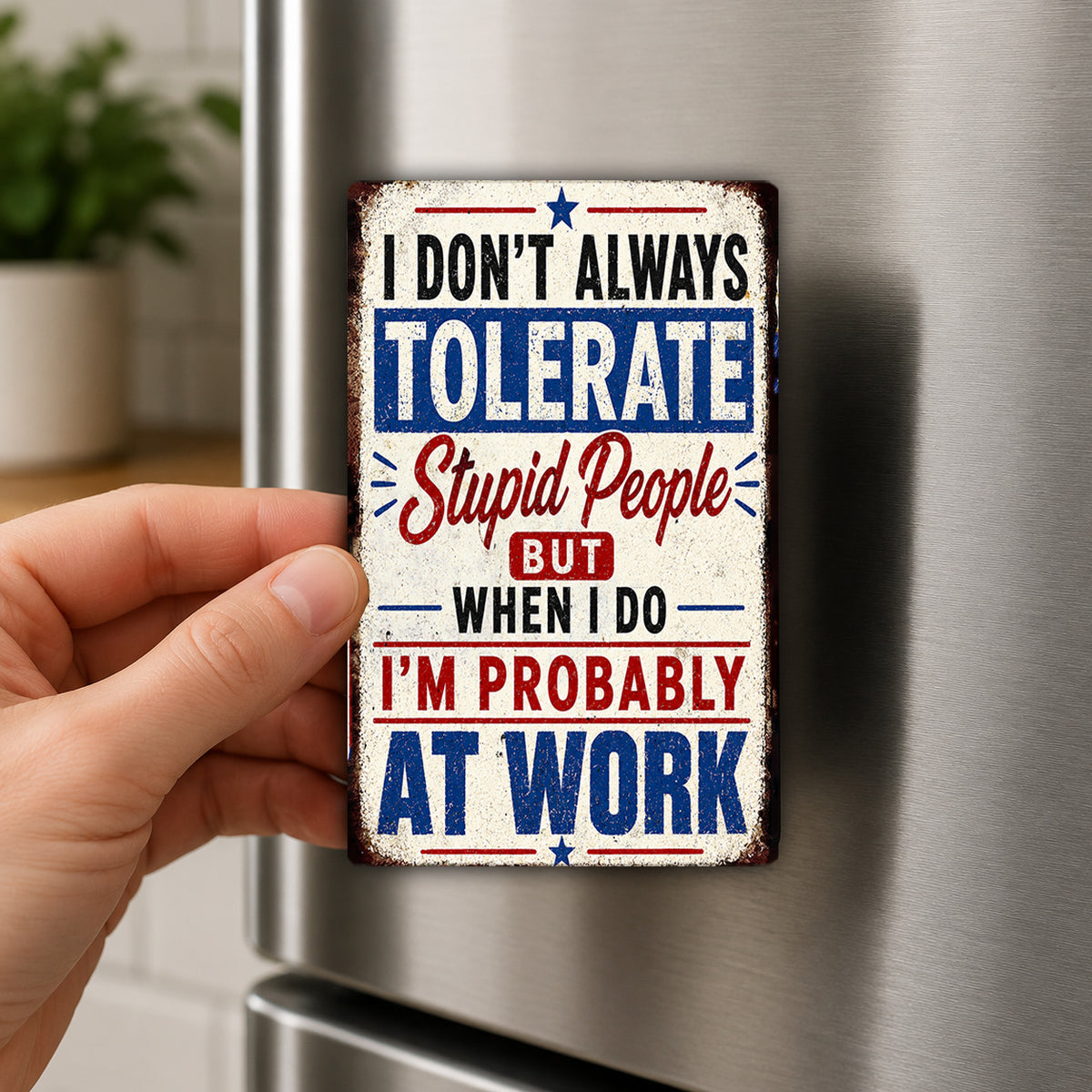 a person's hand holding a metal sign with a humorous message about being intolerant of stupid people at work.