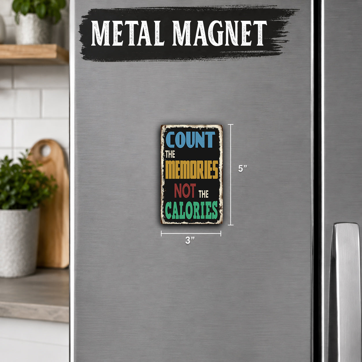 a metal refrigerator with a small, colorful magnet on its surface. The magnet has the text "Count the memories, not the calories" written on it.