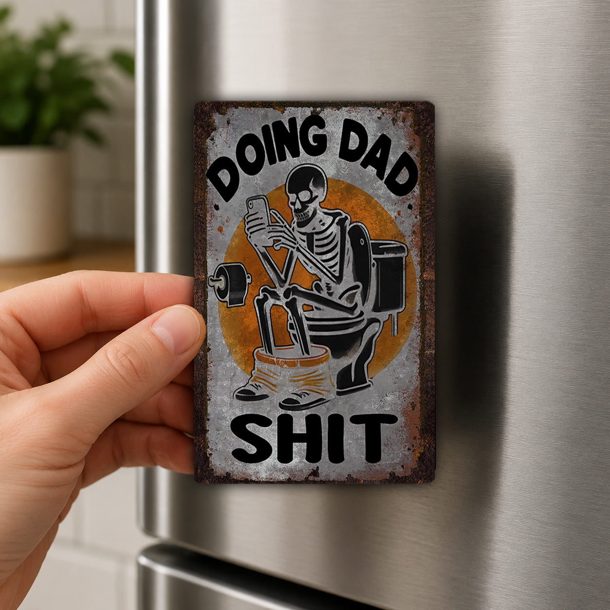 A person's hand is holding a metal sign with a skeleton sitting on a toilet and the text "Doing Dad Shit" on it.