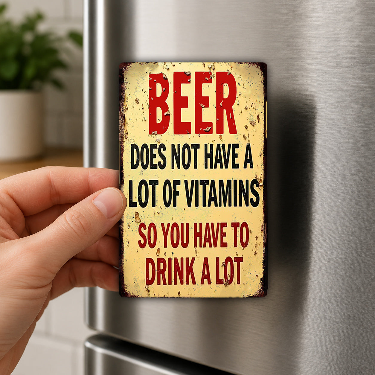 A person's hand holding a sign with the text "BEER DOES NOT HAVE A LITTLE OF VITAMINS SO YOU HAVE TO DRINK A LOT"