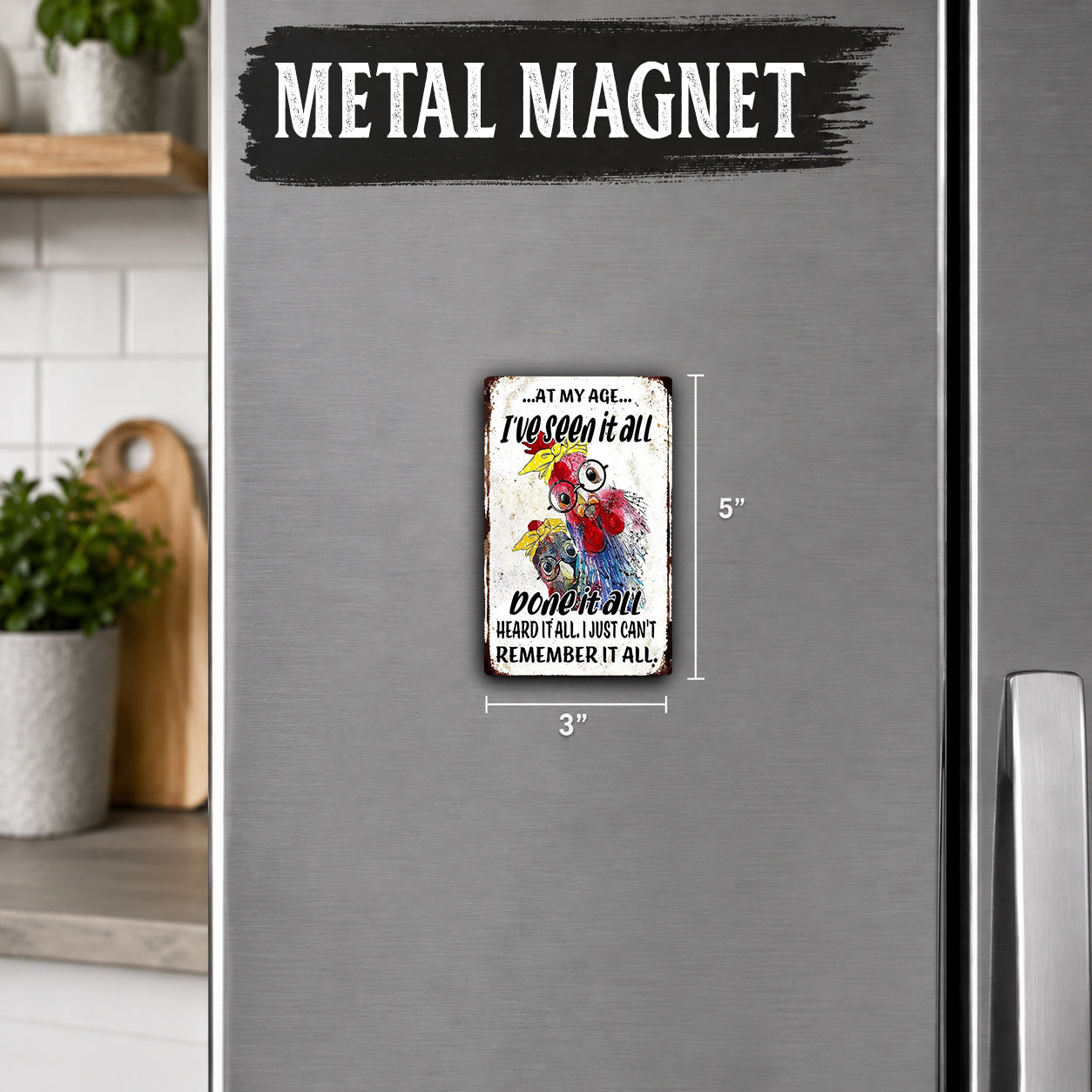 a small metal magnet with a humorous text on it, placed on a refrigerator.