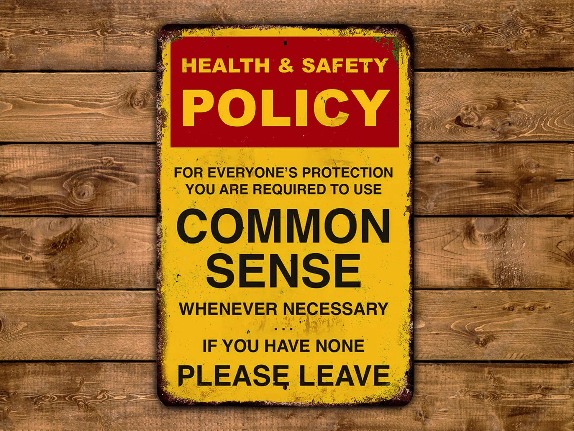 a health and safety policy sign on a wooden wall