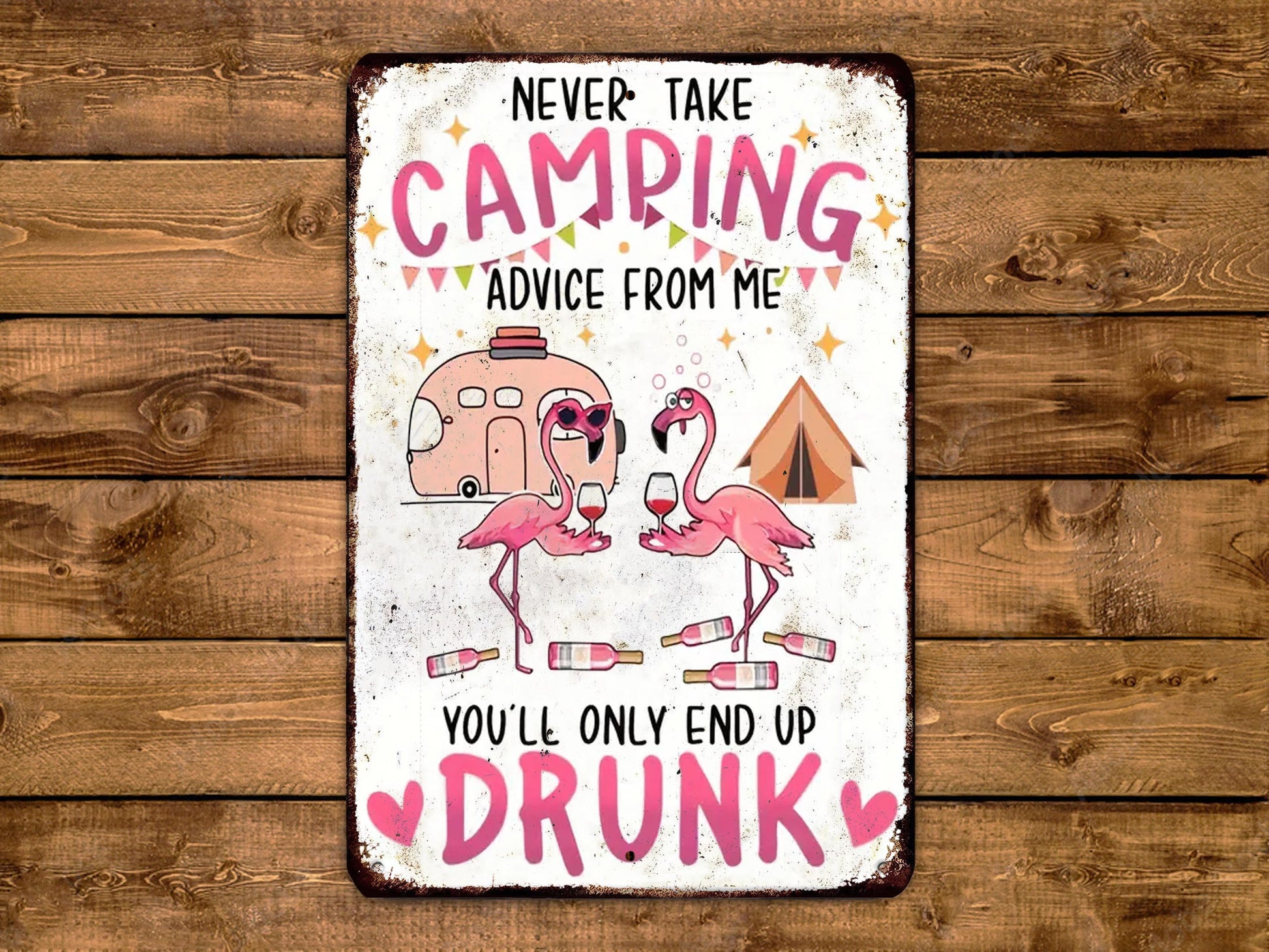 The image is a humorous sign with a cartoon flamingo and camping-related elements, accompanied by the text "Never take camping advice from me, you'll only end up drunk".