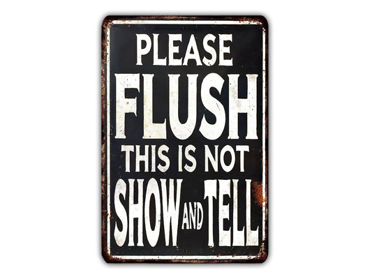 a sign with the text "PLEASE FLUSH THIS IS NOT SHOW AND TELL" in white letters.