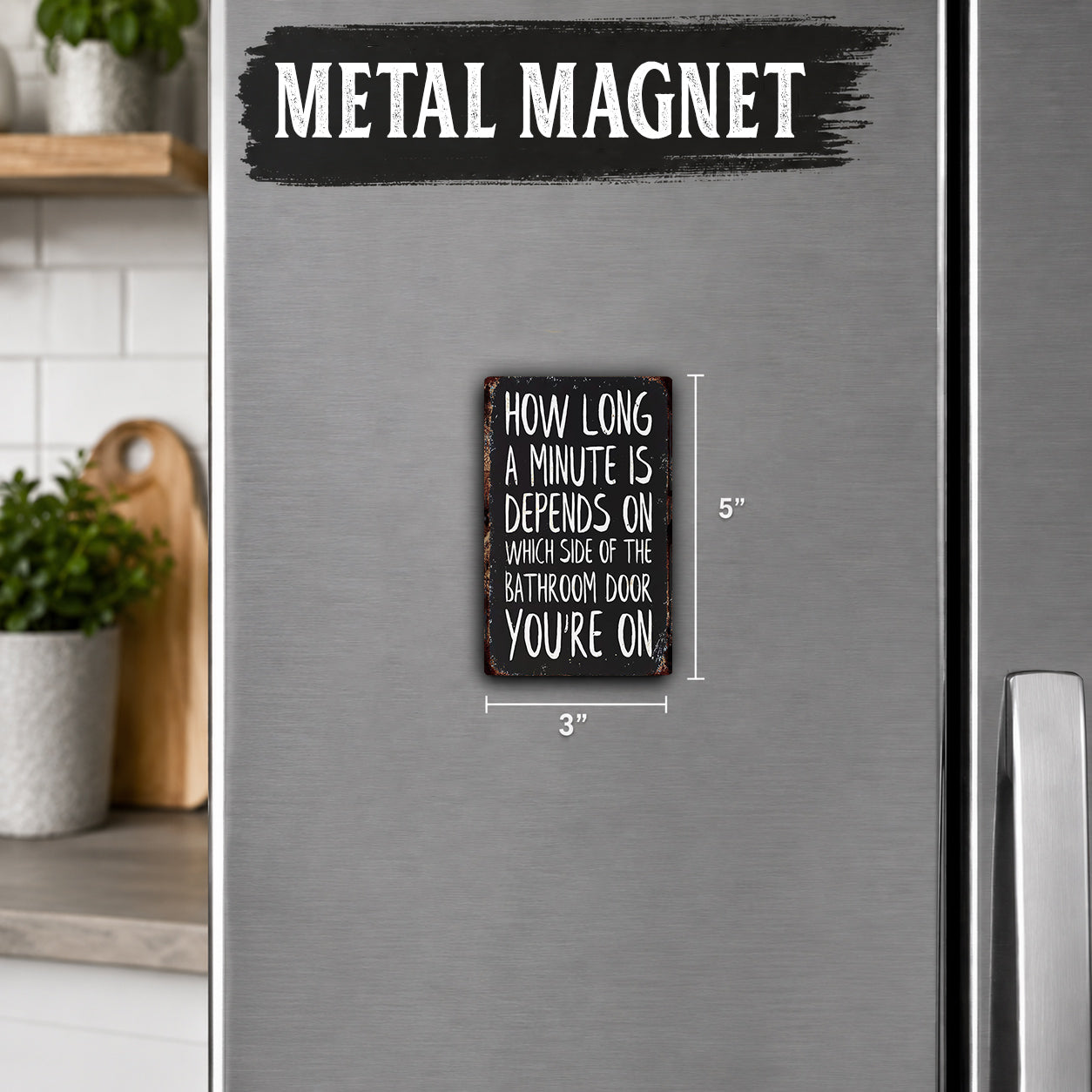 a small metal magnet with a humorous text on it, placed on a refrigerator.