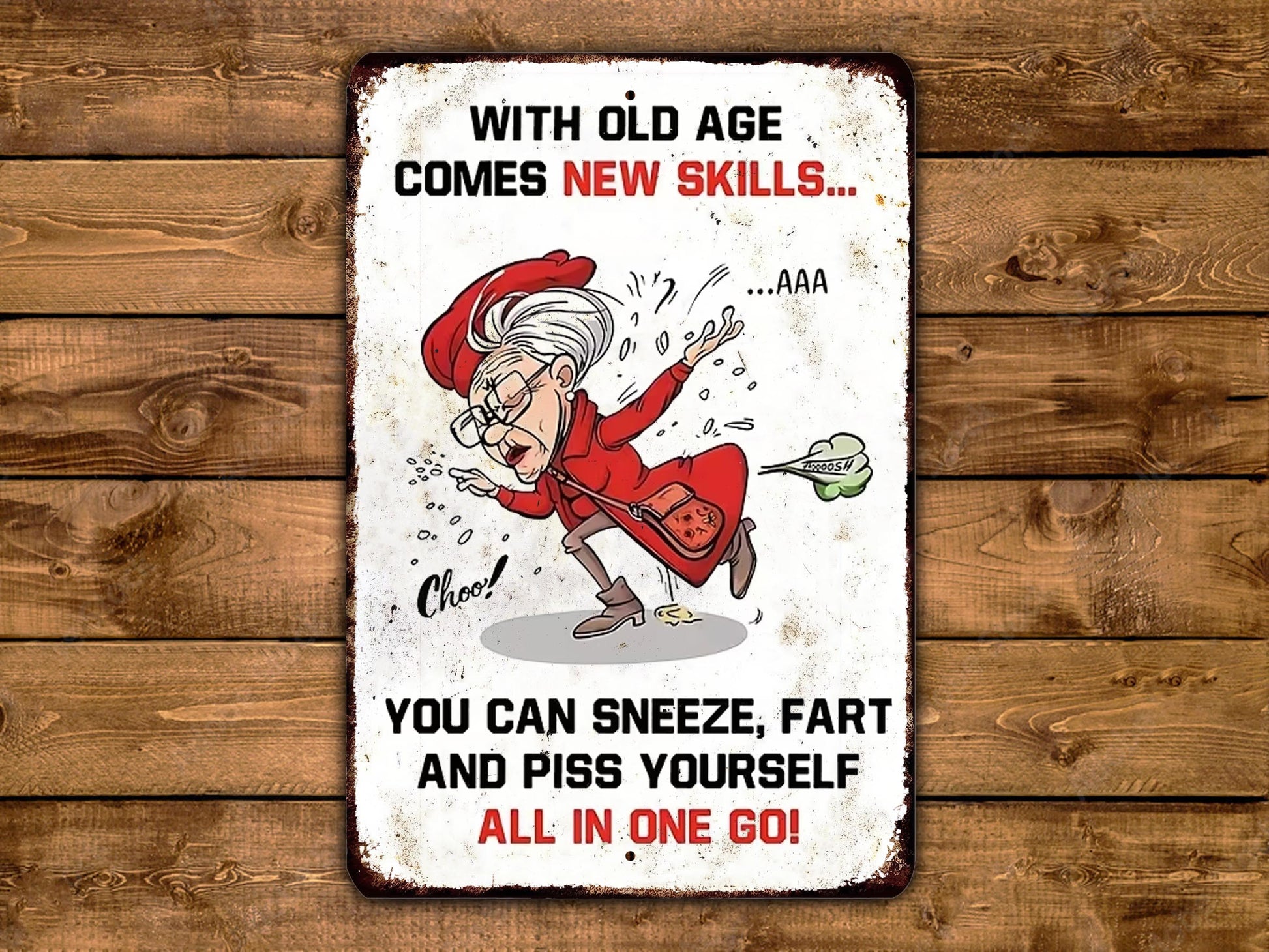 The image is a humorous sign with a cartoon character, likely an elderly woman, who is being advised to "sneeze, fart, and poop yourself all in one go" in a comical manner.