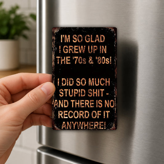 A person's hand is holding a metal sign with text on it, which appears to be a humorous or playful message.