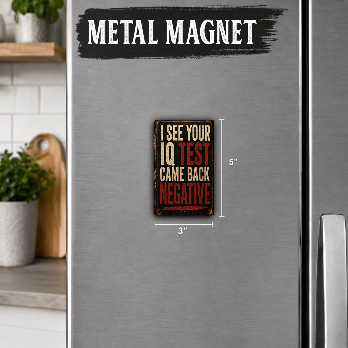 a small, vintage-style magnet with the text "I SEE YOUR IQ TEST CAME BACK NEGATIVE" on it. The magnet is placed on a refrigerator, and there is a wooden cutting board and a potted plant visible in the background.