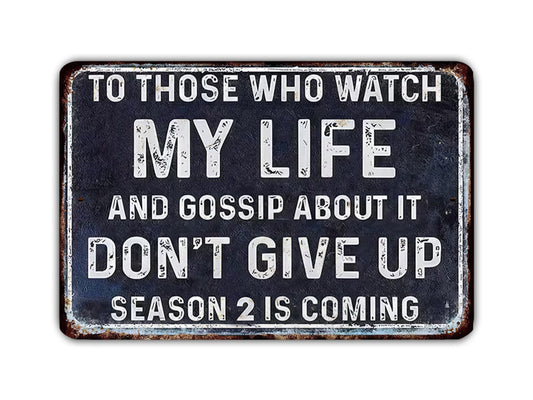 a sign with the text "MY LIFE AND GOSSIP ABOUT IT DON'T GIVE UP SEASON 2 IS COMING" in white letters on a black background.