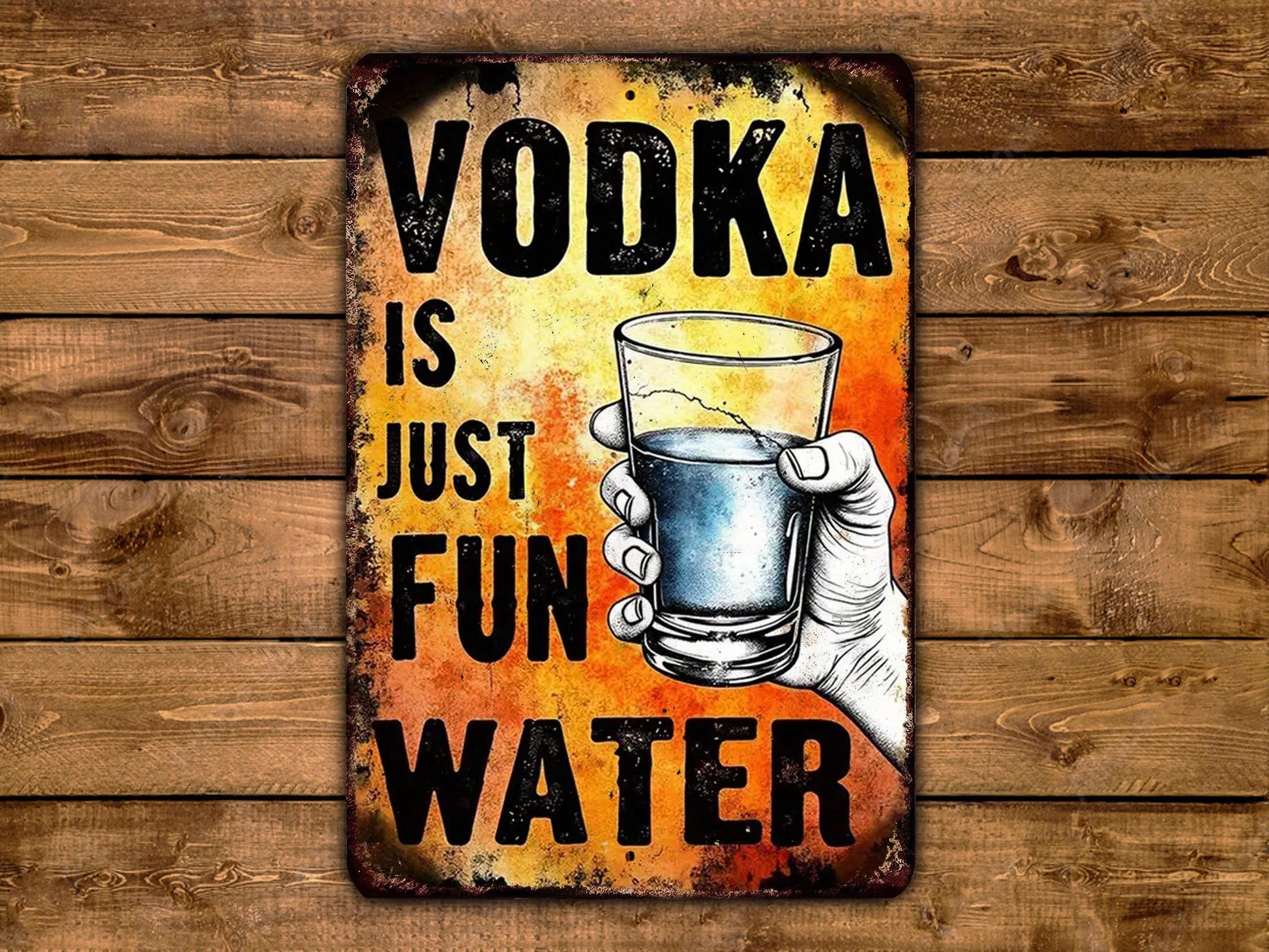 a hand holding a glass of water with the text "VODKA IS JUST FUN WATER" written on it.
