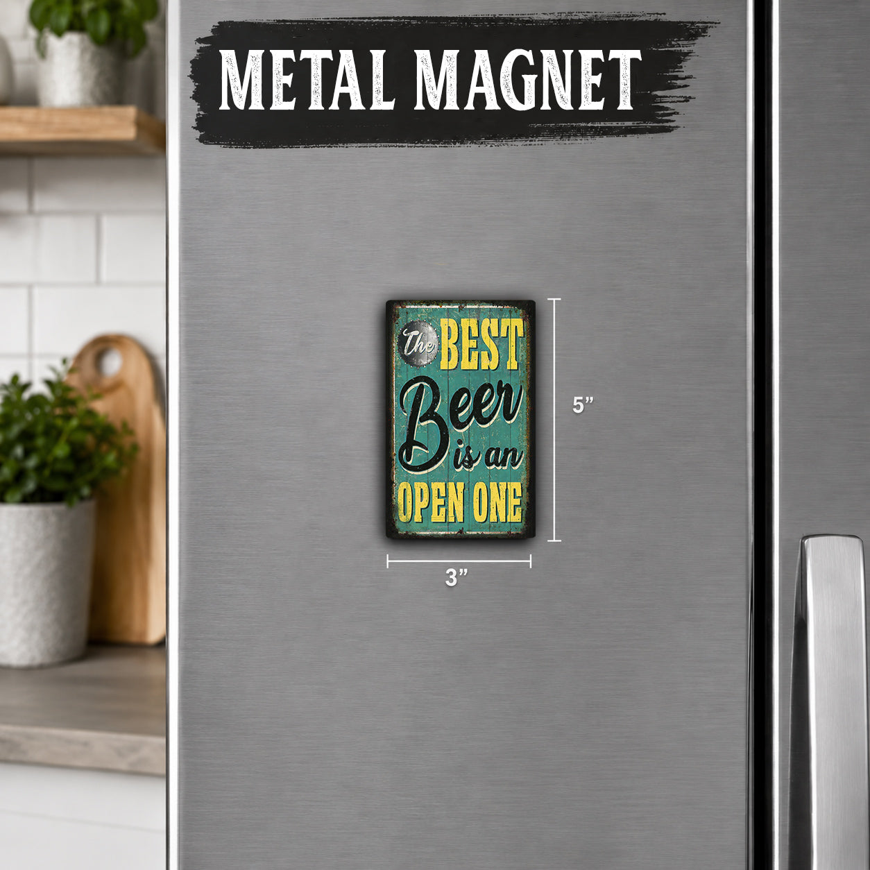 a small, vintage-style magnet on a refrigerator door with the text "The best Beer is an open one" and dimensions provided.