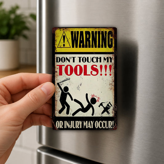A person is holding a metal sign with a warning message about not touching someone's tools.