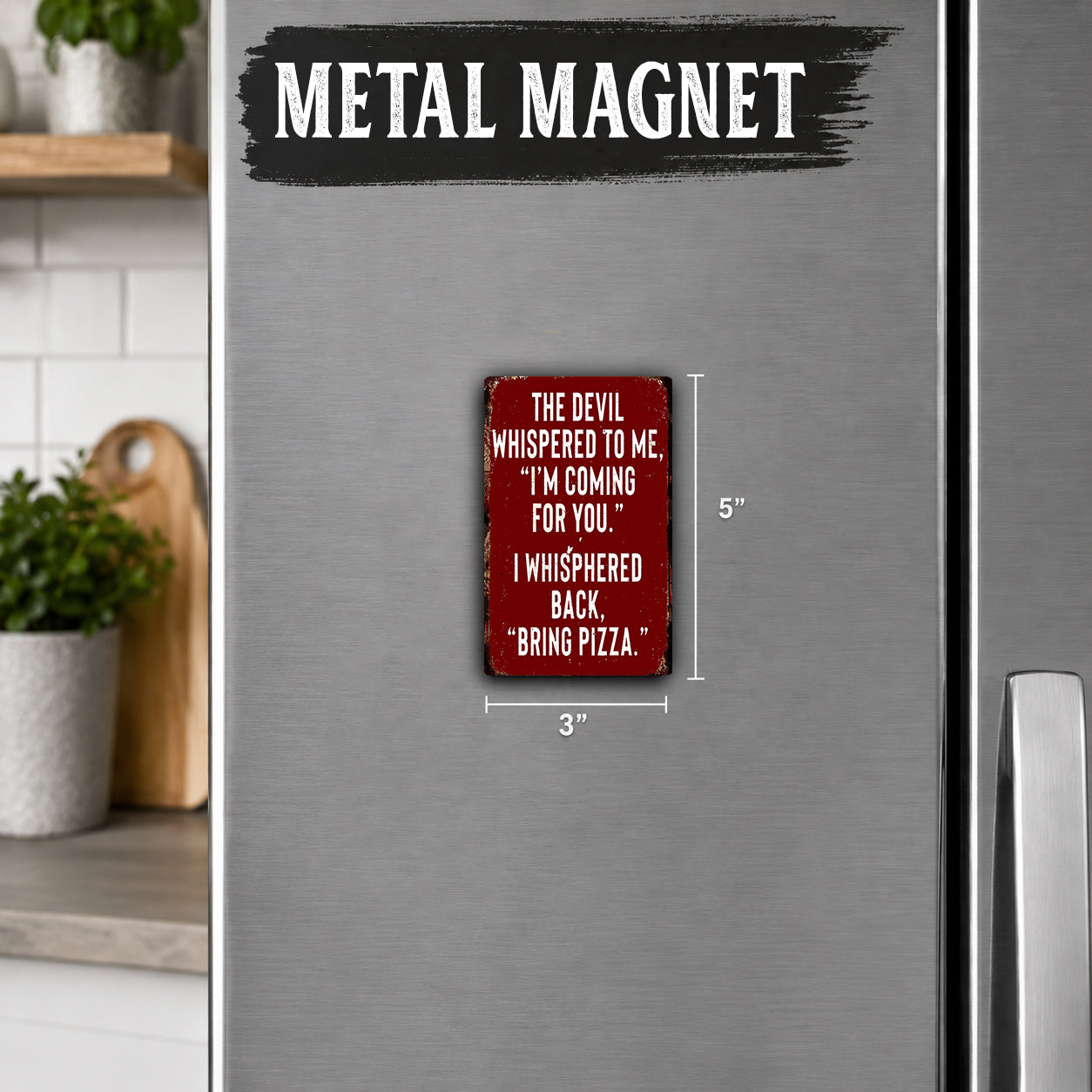 a red metal magnet with a humorous text quote on it, placed on a stainless steel refrigerator.