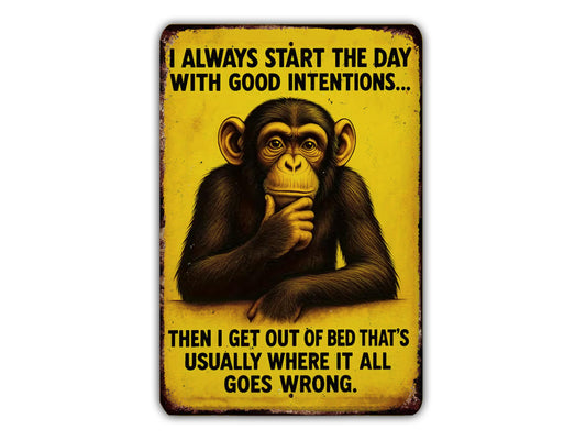 a monkey sitting on a bed with the text "I always start the day with good intentions...THEN I GET OUT OF BED THAT'S USUALLY WHERE IT ALL GOES WRONG."