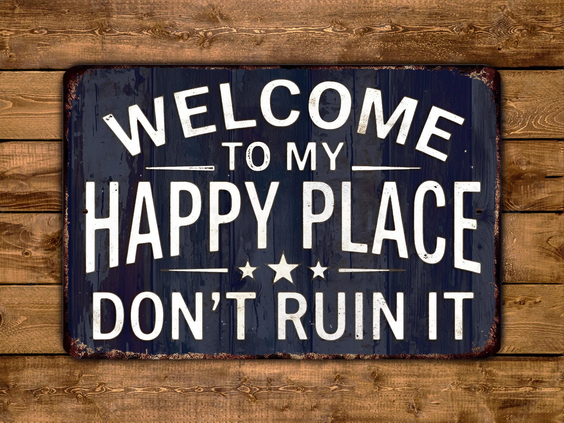 a sign with the text "Welcome to my happy place don't ruin it" in white letters against a dark background.