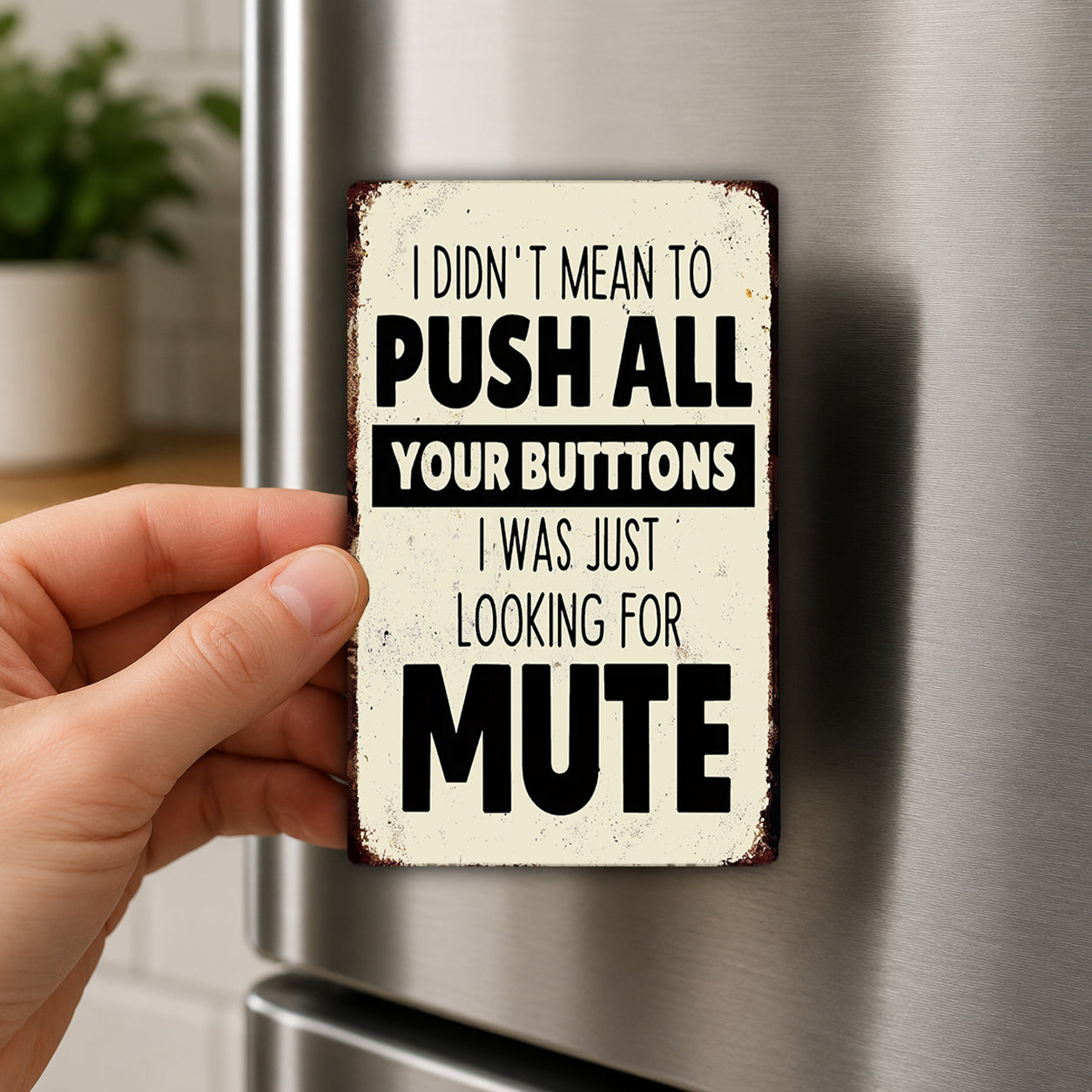 A person's hand holding a sign with the text "I DIDN'T MEAN TO PUSH ALL YOUR BUTTONS I WAS JUST LOOKING FOR MUTE" on it.