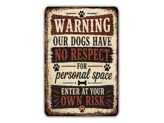a sign with the text "WARNING OUR DOGS HAVE NO RESPECT FOR PERSONAL SPACE ENTER AT YOUR OWN RISK" in a vintage style.