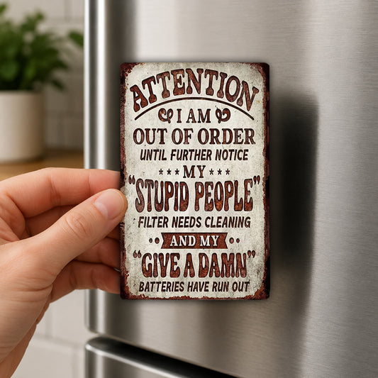 a person holding a metal sign with a humorous message on it.