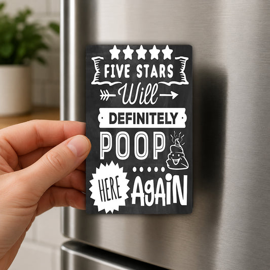 A hand holding a black and white magnet with text on it, which appears to be a humorous or playful message.