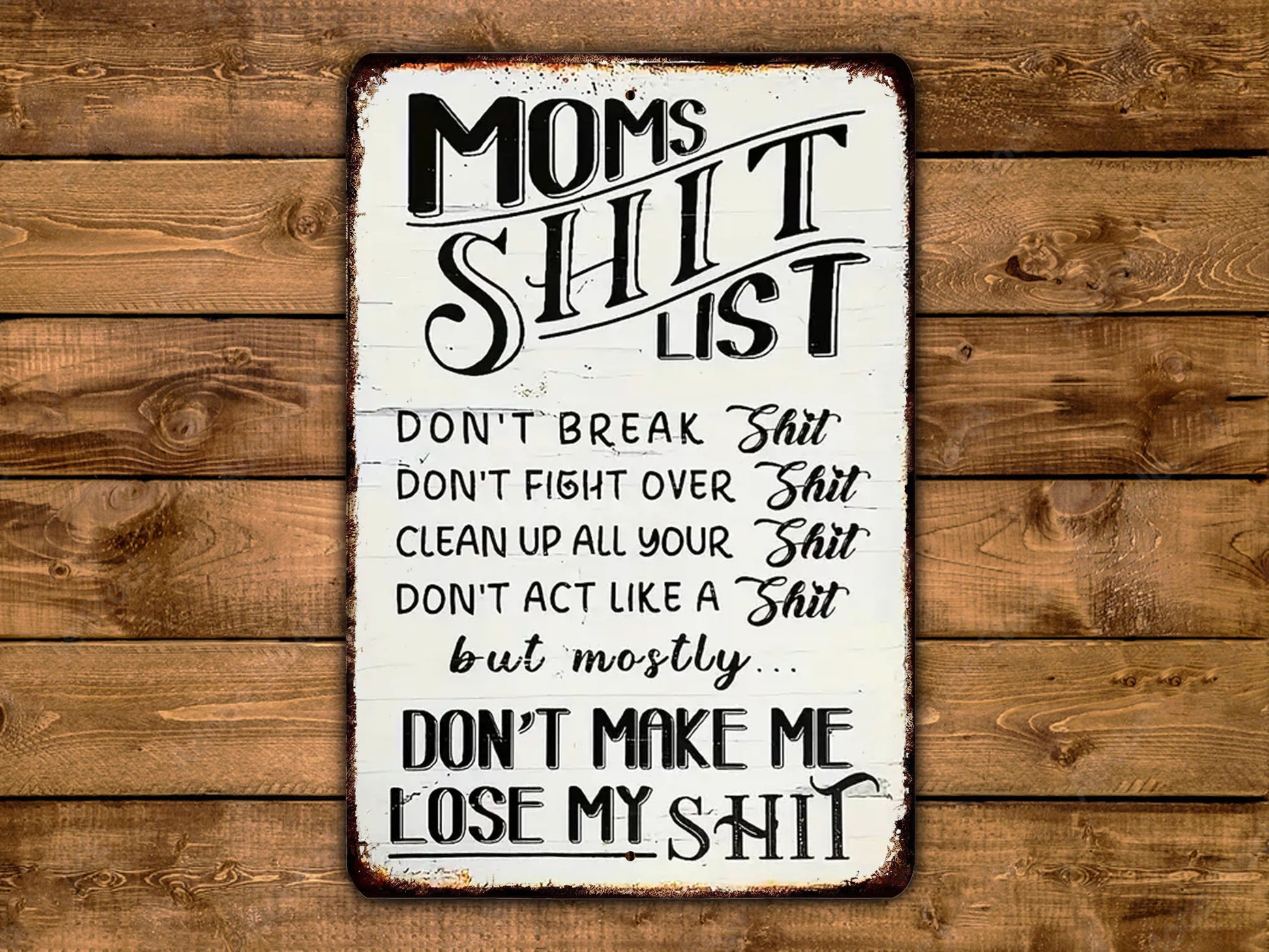 a sign on a wooden wall that says mom's shit list