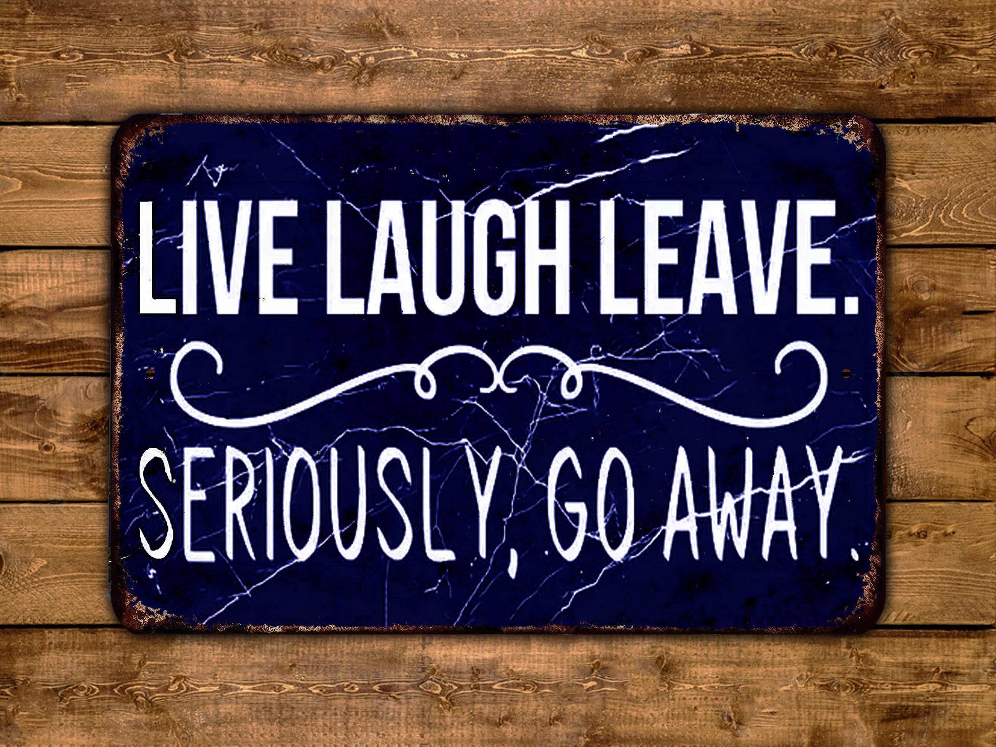 a sign that says live laugh leave seriously go away