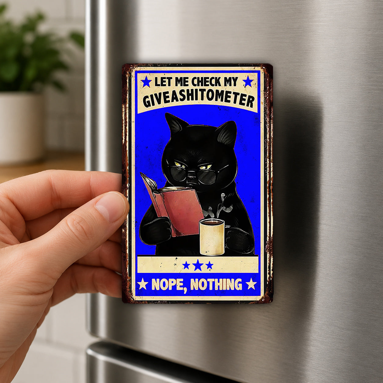 A person's hand holding a metal refrigerator magnet with a cartoon image of a black cat and text that reads "Let me check my giveashitometer NOPE, NOTHING".