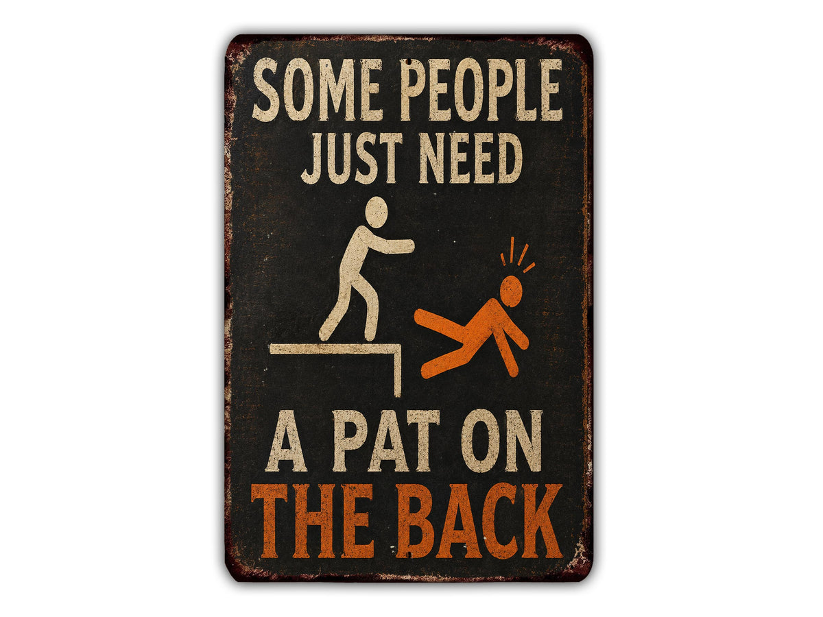 a sign with the text "Some people just need a pat on the back" and an illustration of a person being pushed or pushed off a ledge.