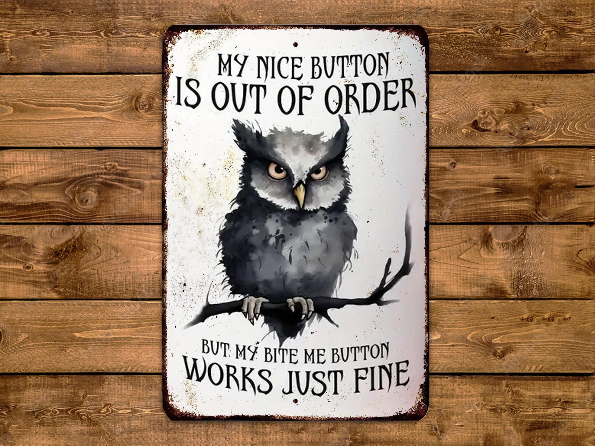 a sign with an owl on a branch, accompanied by the text "My nice button is out of order but my bite me button works just fine".