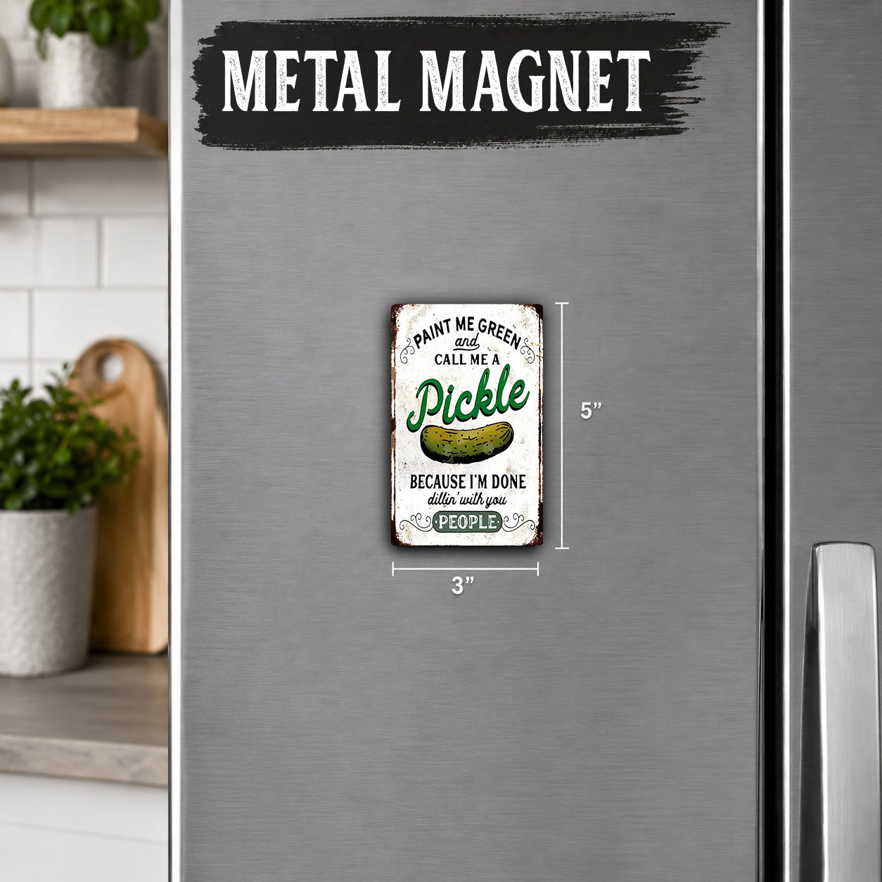 a small, vintage-style metal magnet with a humorous message about pickles.