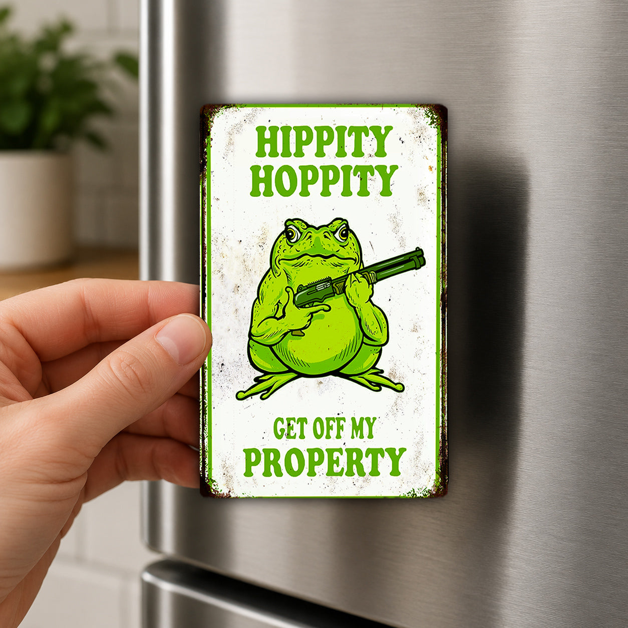 A person is holding a metal sign with a cartoon frog and the text "Hippity Hoppy Get off my Property" on it.