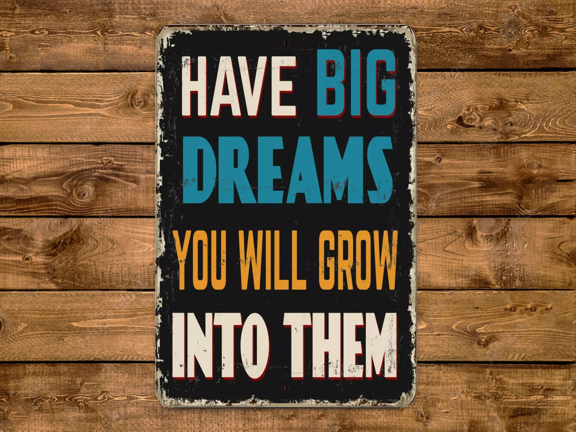 a sign that says have big dreams you will grow into them