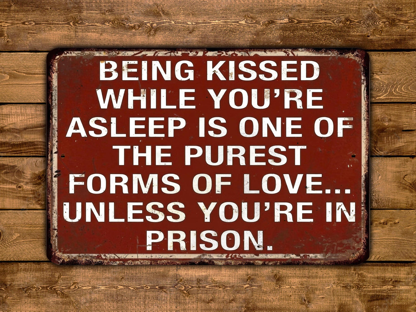 a sign with a message about love and relationships, stating that being kissed while asleep is one of the purest forms of love, unless the person is in prison.