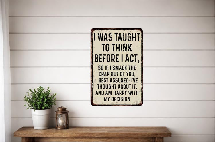 a humorous sign with a wooden bench and a potted plant in the background.