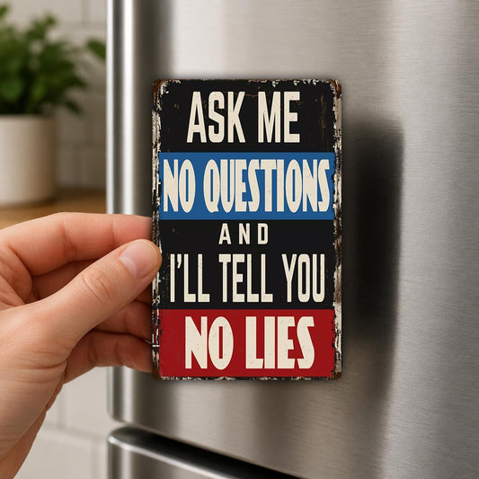 A person's hand is holding a small metal sign with the text "Ask me no questions and I'll tell you no lies" on it.