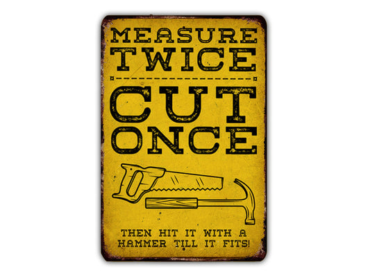 The image is a vintage-style sign with the text "MEASURE TWICE CUT ONCE" and an illustration of a hammer and saw.