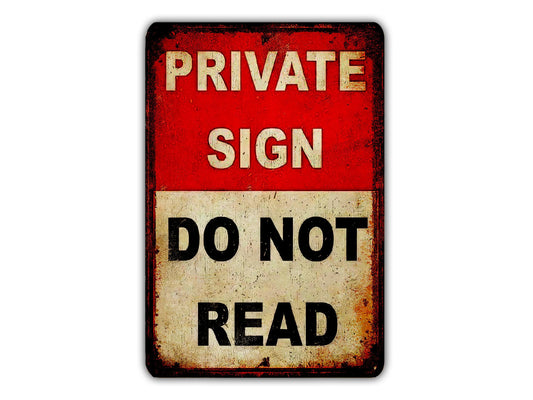a red and white sign with the text "PRIVATE SIGN DO NOT READ".