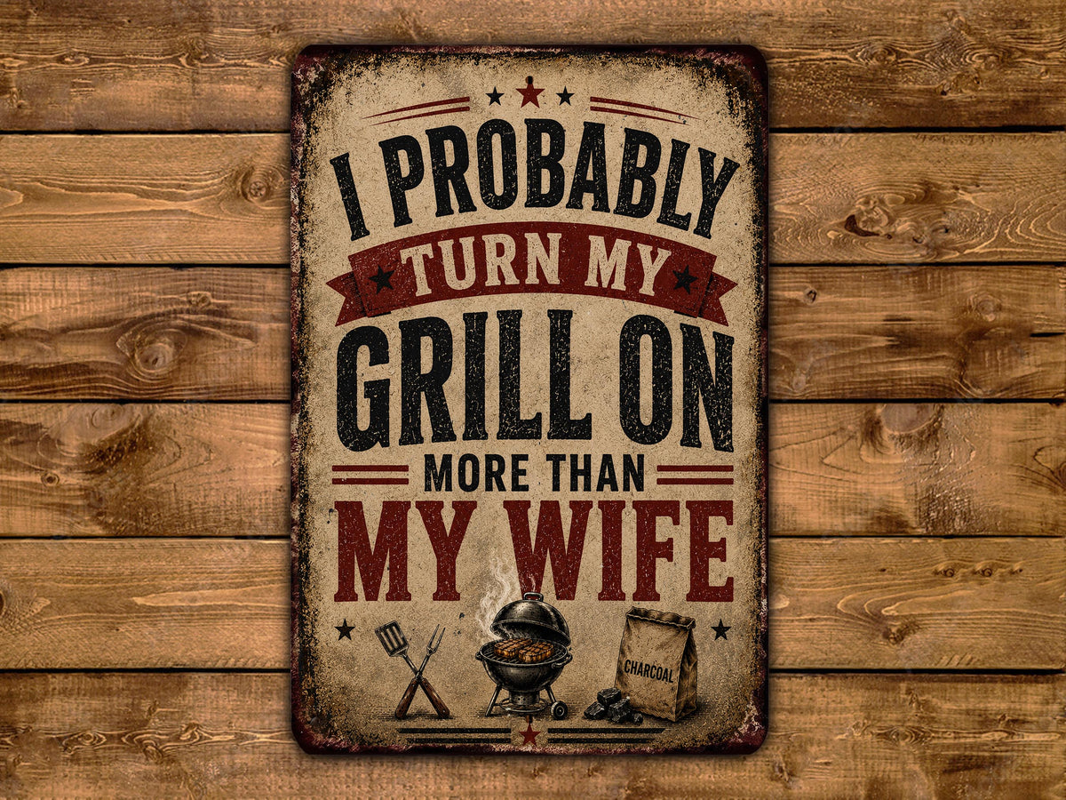 a vintage-style sign with the text "I PROBABLY TURN MY GRILL ON MORE THAN MY WIFE" displayed prominently.
