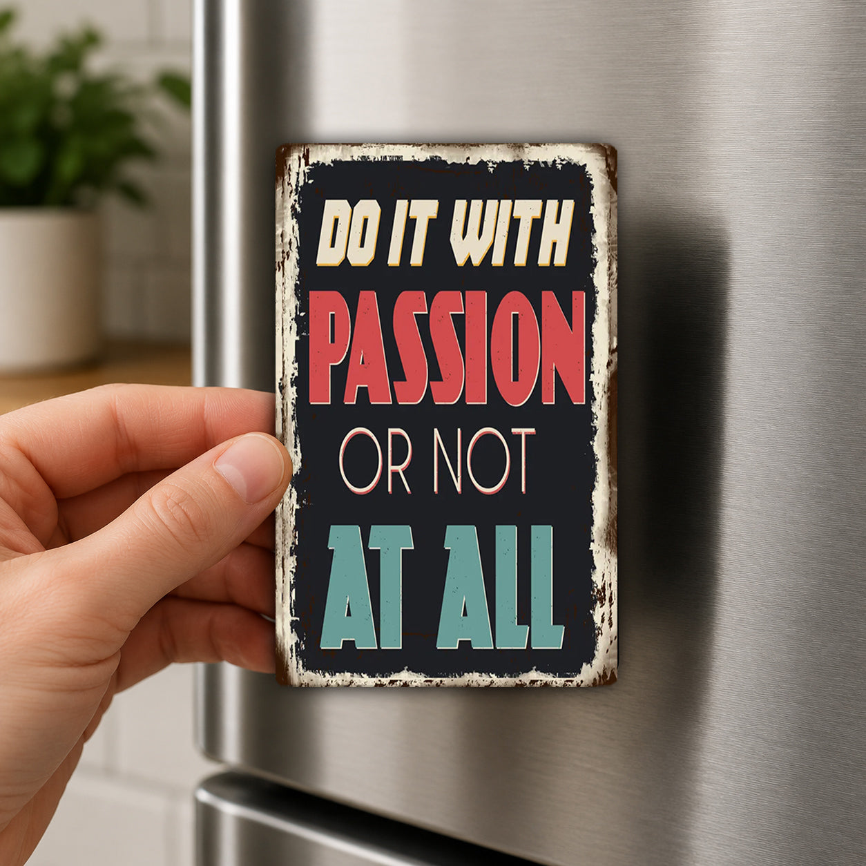 A person's hand holding a metal sign with the text "Do it with passion or not at all" on it.