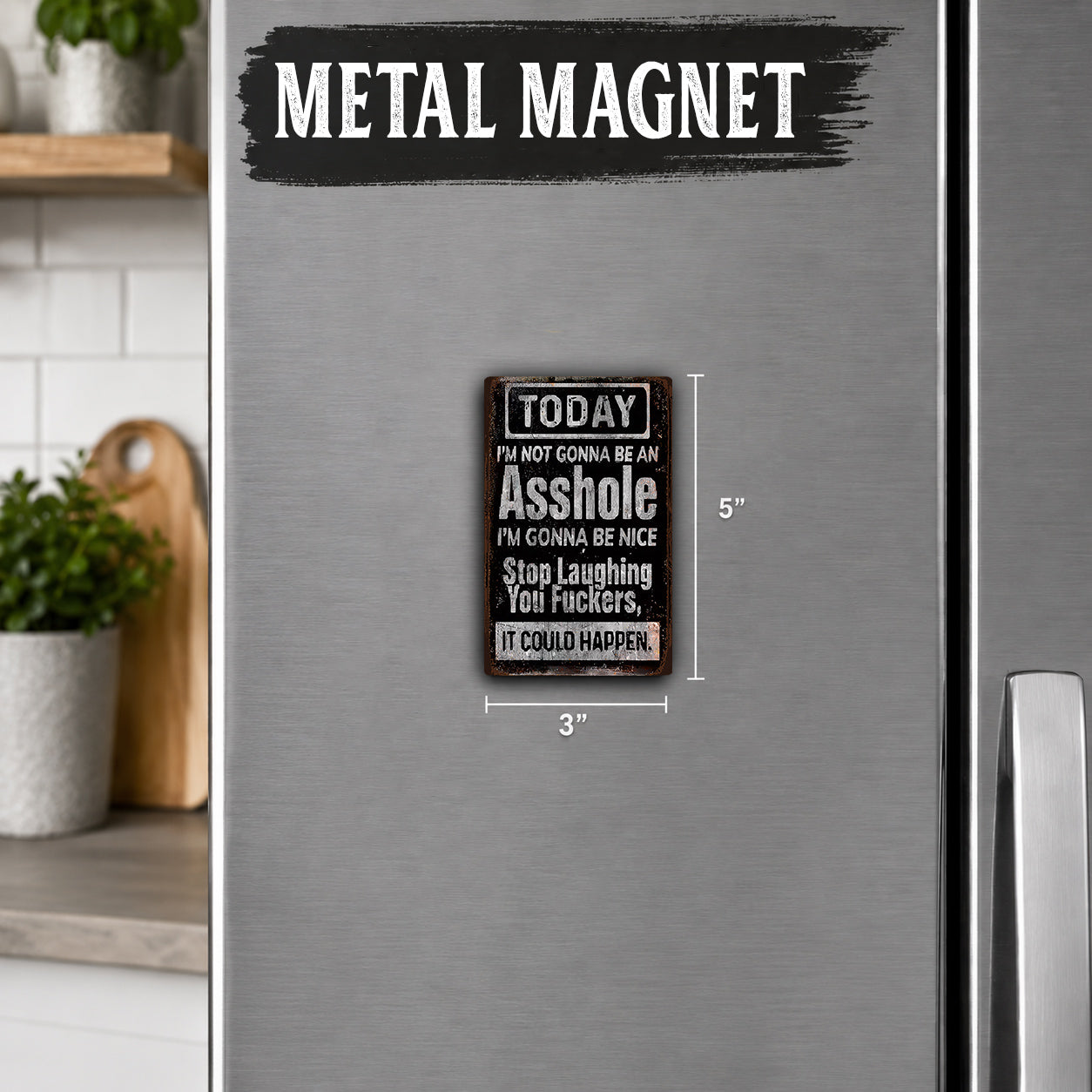 a small, metal-colored refrigerator with a humorous sign attached to it. The sign reads "TODAY I'M NOT GONNA BE AN ASSHOLE I'M GONNA BE NICE. STOP LAUGHING YOU'LL HAPPEN. IT COULD HAPPEN." The sign is approximately 5 inches in size.