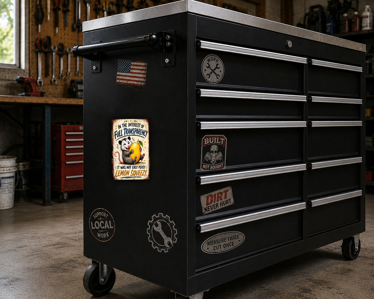 A black workbench with various stickers and labels on it, including a vintage-style lemon squeezer sticker.