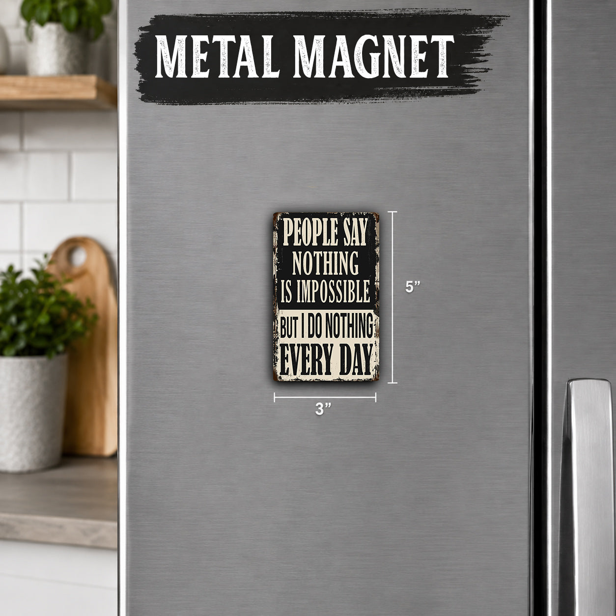 a small metal magnet with a humorous quote on it, placed on the surface of a refrigerator.