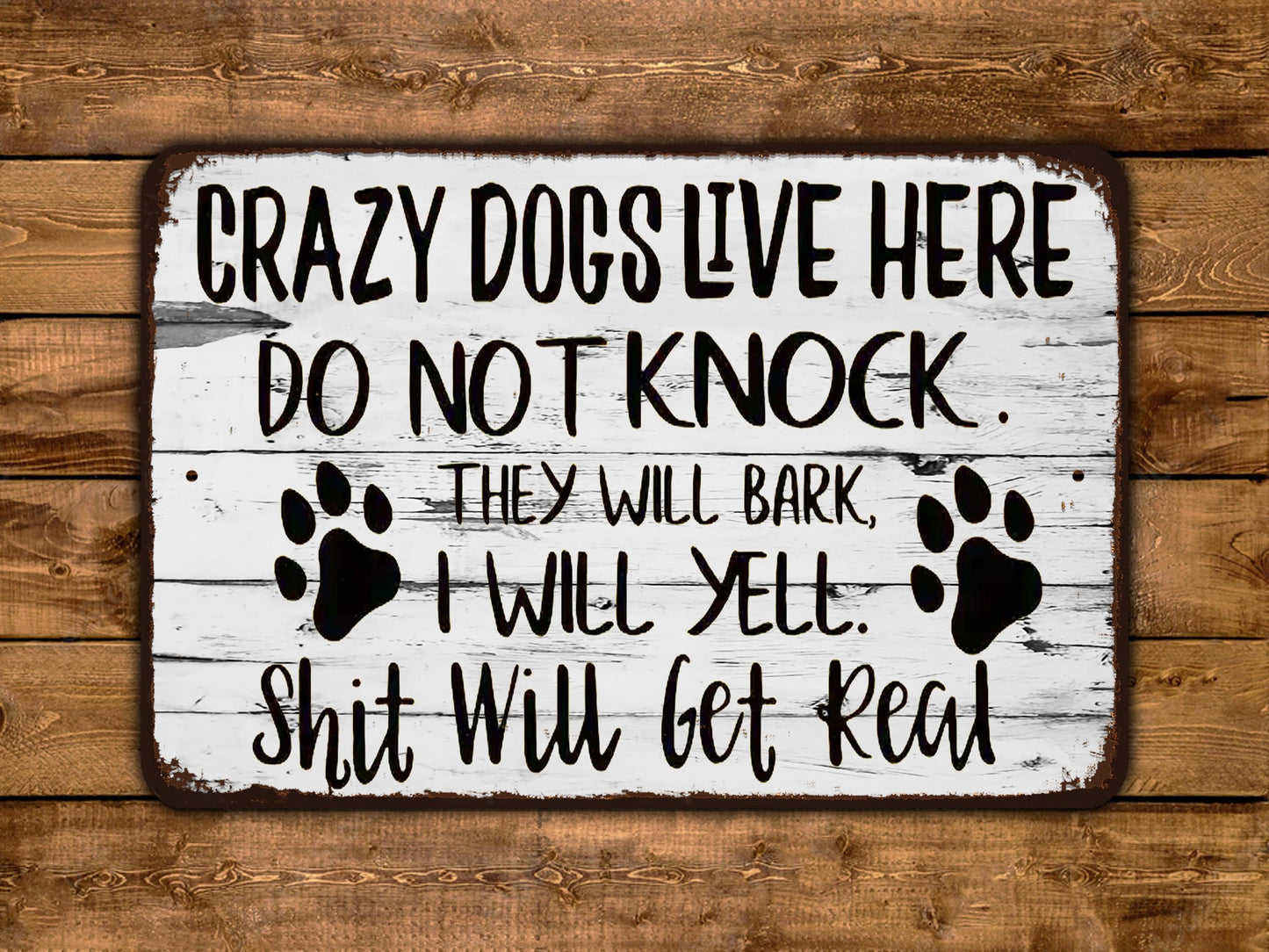 a sign that says crazy dogs live here do not knock they will bark i will