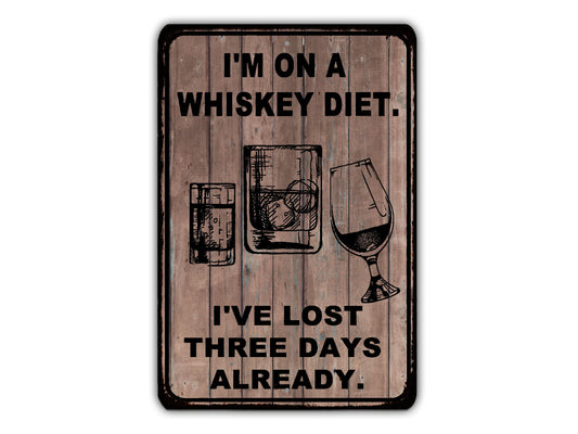 a sign that says i'm on a whiskey diet i've lost three