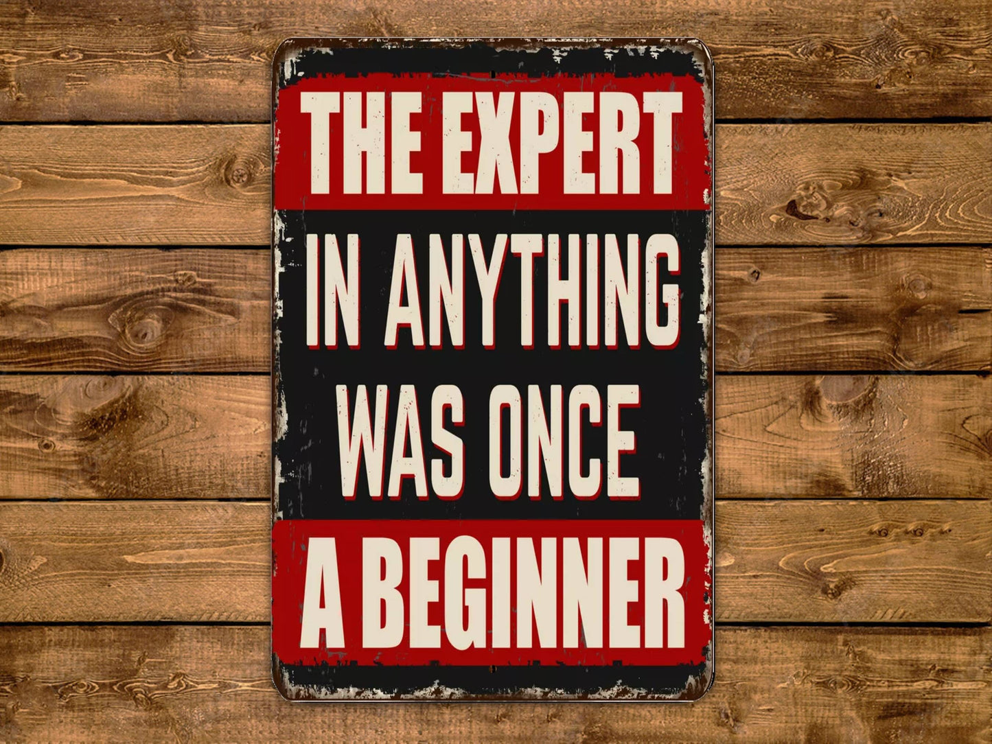 a sign that says the expert in anything was once a beginner