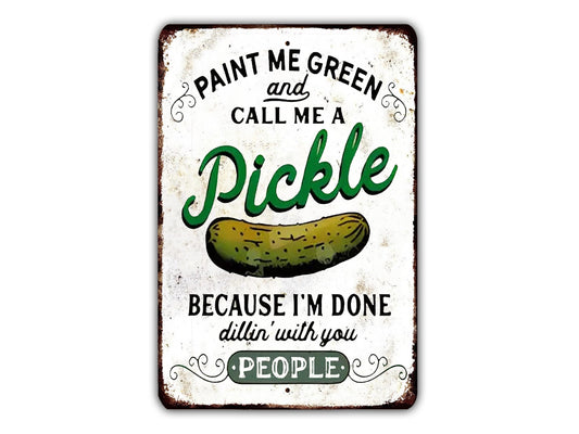 a metal sign with a pickle on it