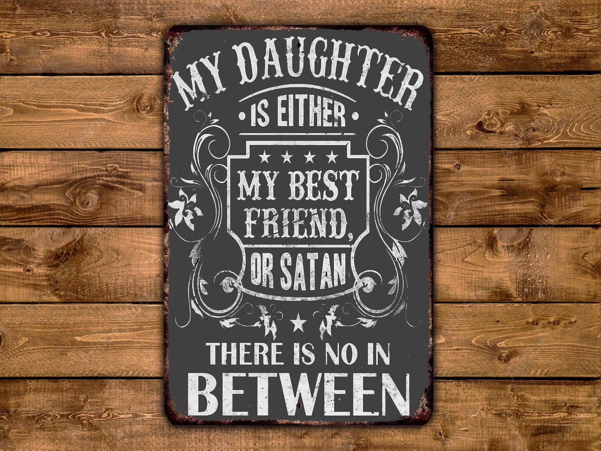 a metal sign that says, my daughter is either my best friend or satan there