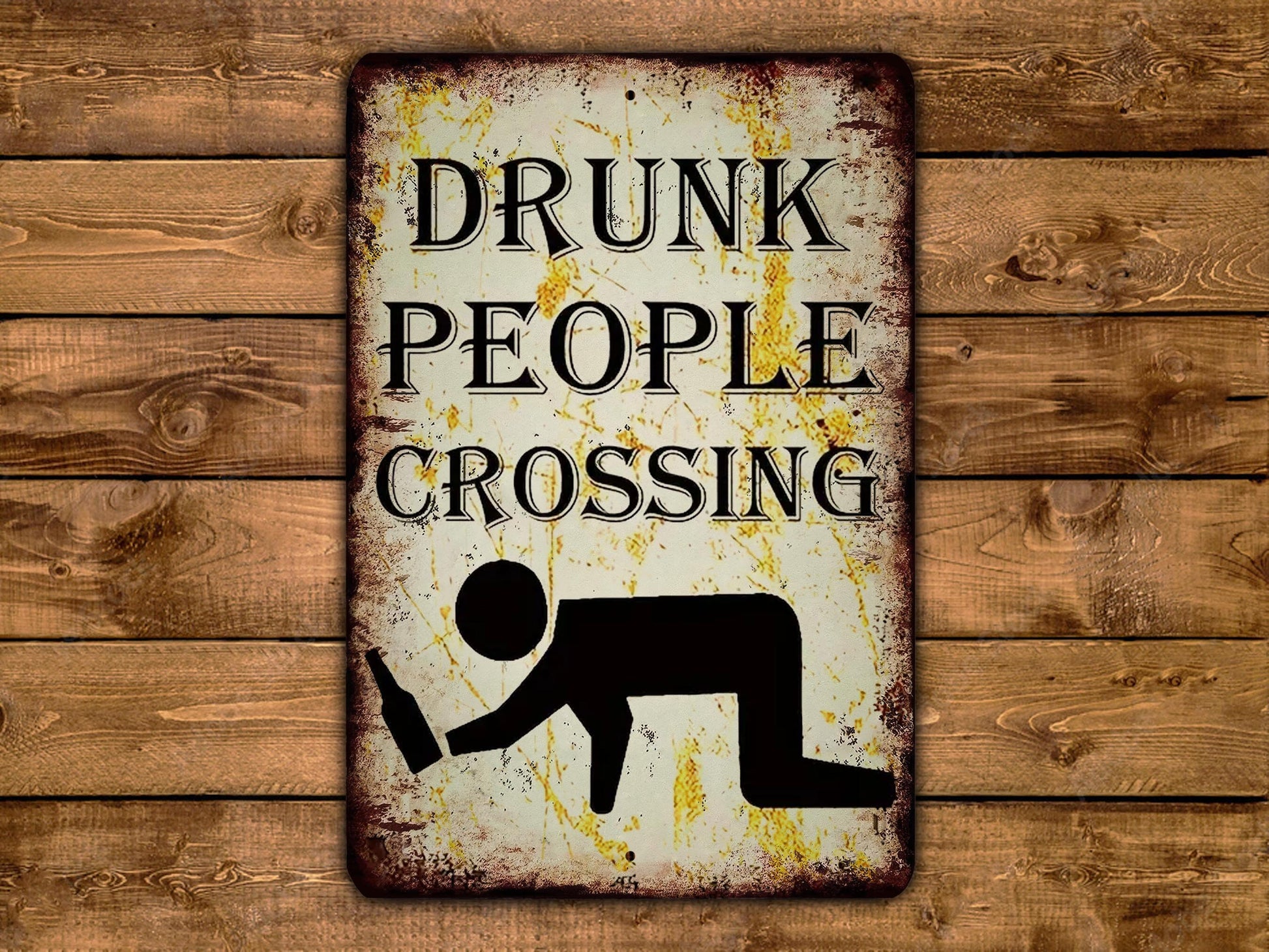 a metal sign that says drunk people crossing